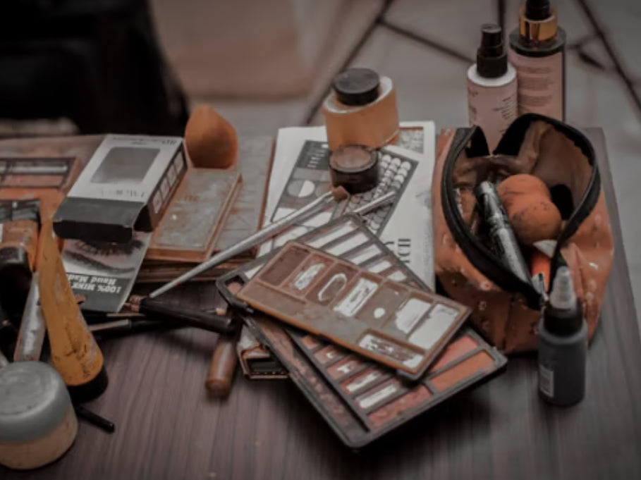 Accessoires de maquillage sales avec pinceaux, palettes et cosmétiques sur une table — besoin de nettoyage avec DiBrush, nettoyeur de pinceaux Dr Make-up.